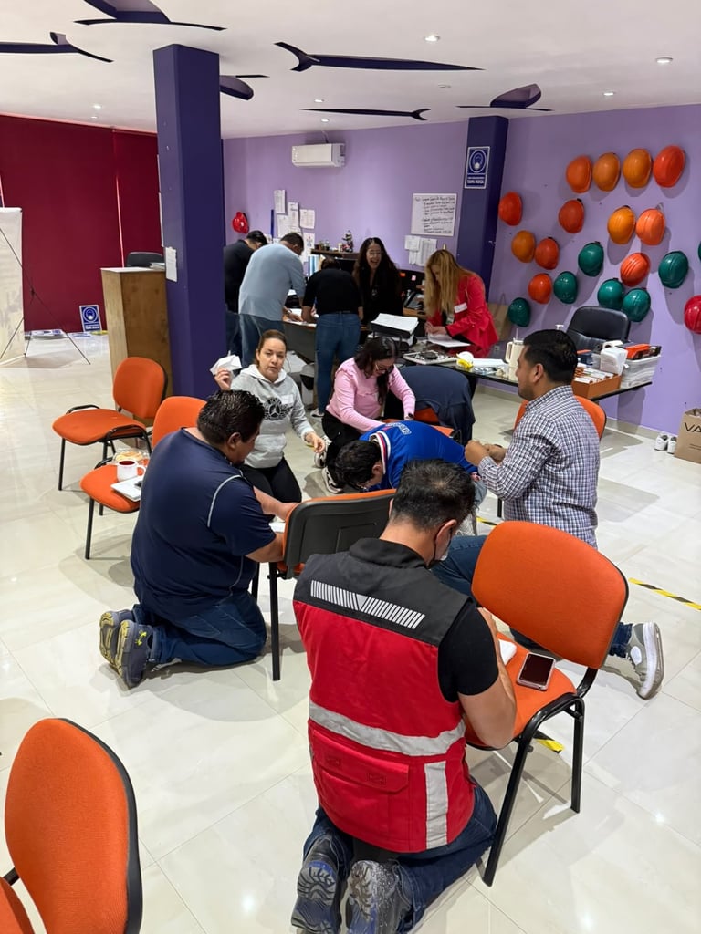 Community group activity in a colorful indoor space with purple walls, orange chairs, and balloons, people gathered together